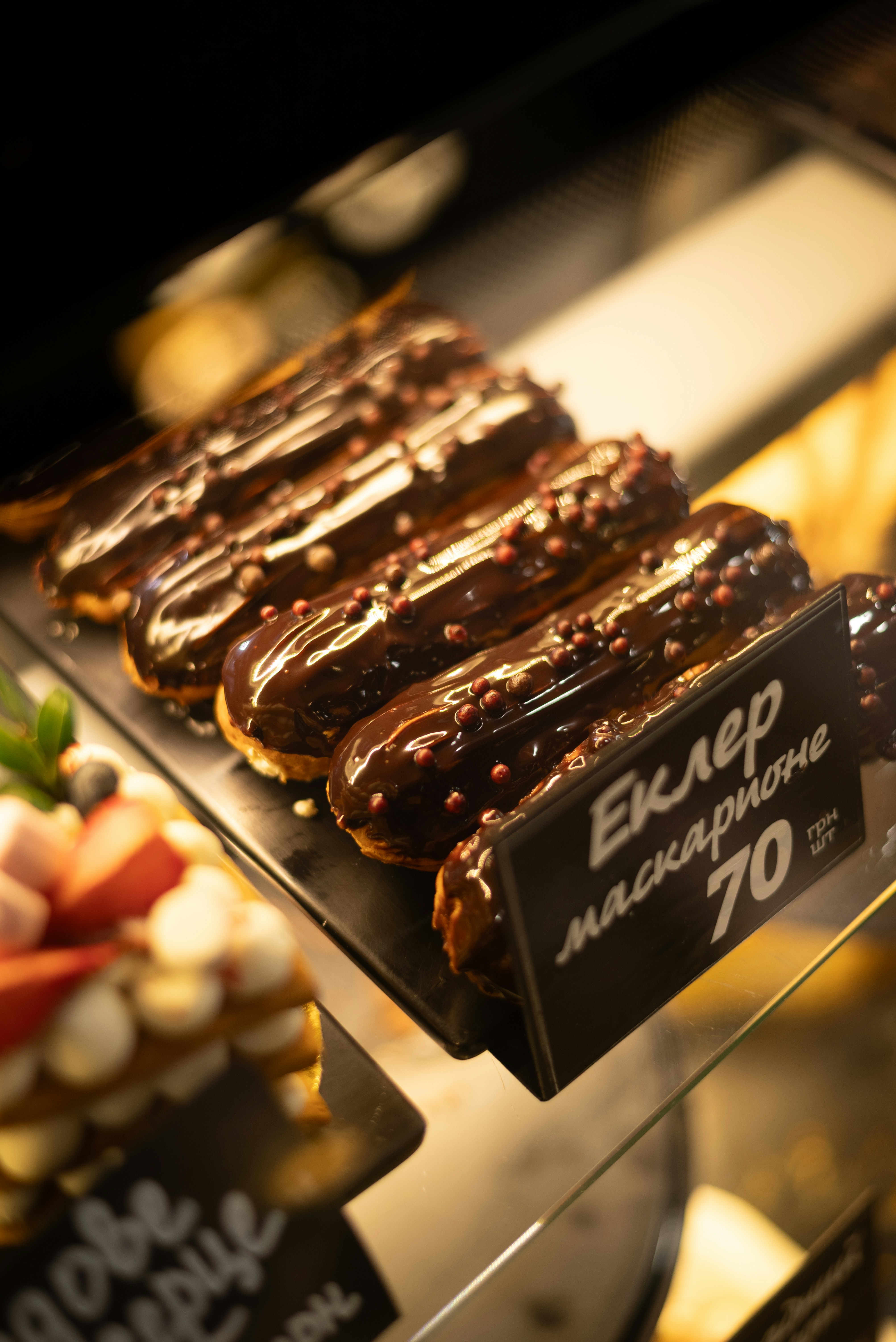 Delicious chocolate eclairs sit on display
